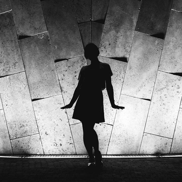 Silhouette of a person standing in a balanced, powerful pose.