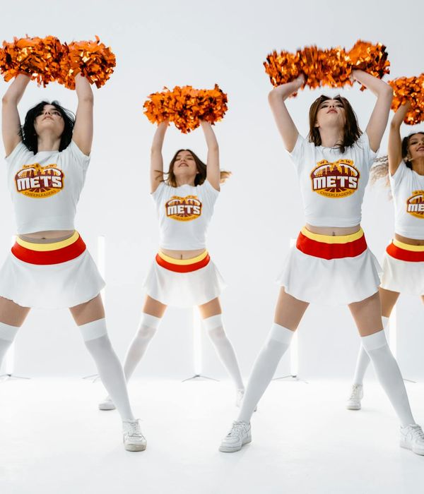 Woman performing a fluid cardio movement in a bright studio.